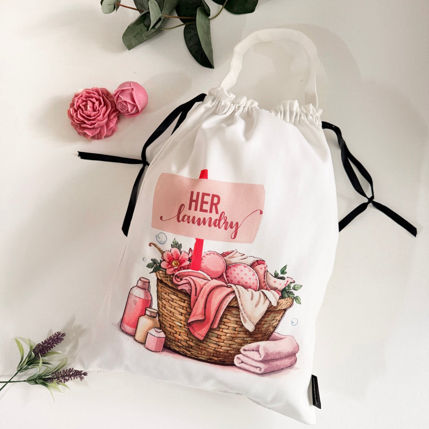 White drawstring bag with laundry-themed design and 'HER laundry' text on the bags background.