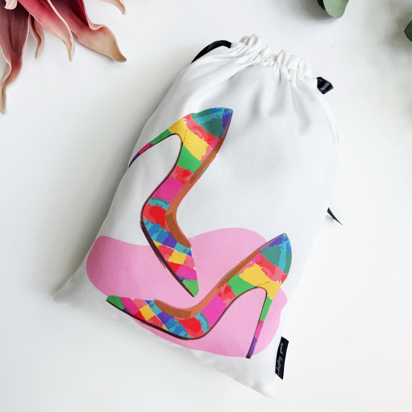 Drawstring bag with colorful high-heeled shoe design on a white background